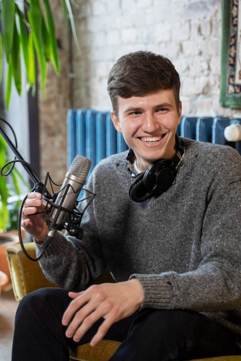 man-with-microphone-headphones-running-podcast-studio (1)